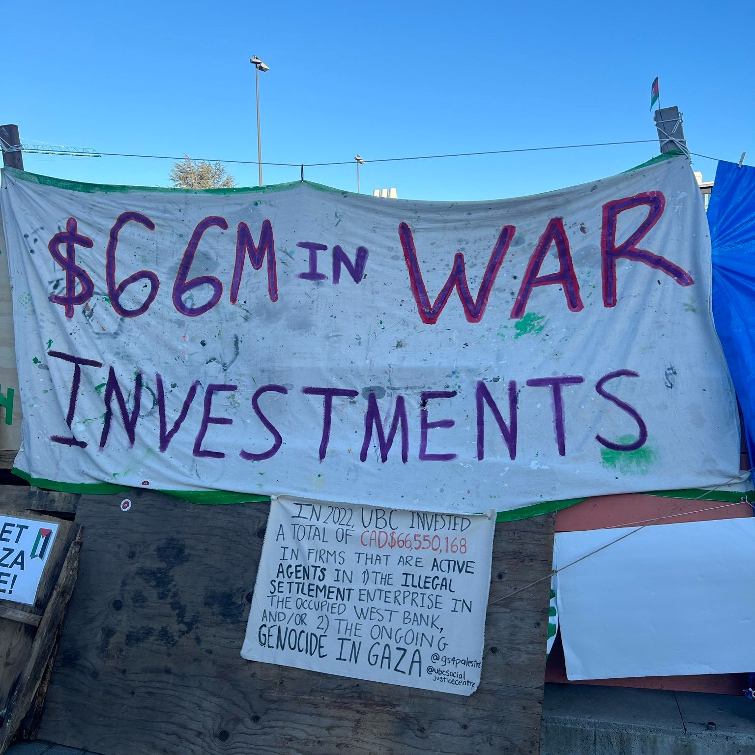 a banner at the UBC student encampment that says 66 million dollars in war investments